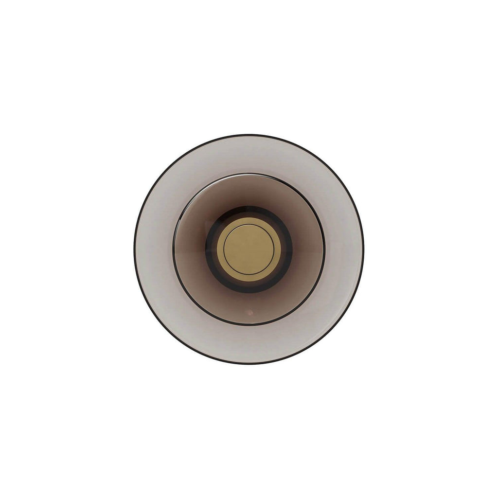 Front view of a Clérachic wall light with a smoked-glass disc, a gold centre cap and a thin dark rim, on a white backdrop.