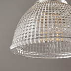 Close view of the grid-cut texture on the clear glass dome of this Clérachic ceiling light, with a bulb faintly visible inside.