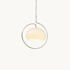 White glass Clérachic pendant light with a chrome ring and hook arm, hung from a fine chain against a plain off-white backdrop.