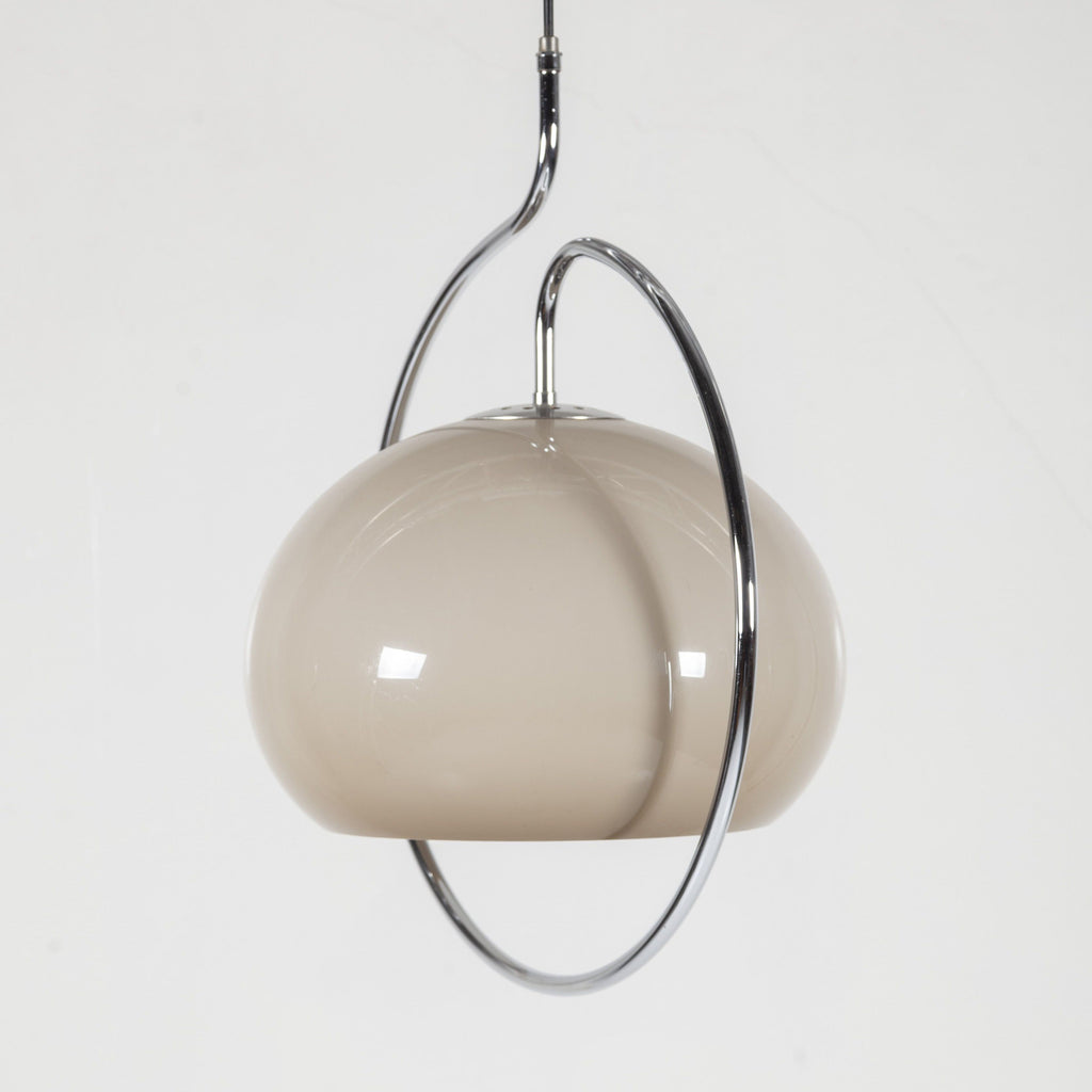 Clérachic glass dome pendant in a soft grey-taupe tone, tilted inside its chrome ring against a pale background.