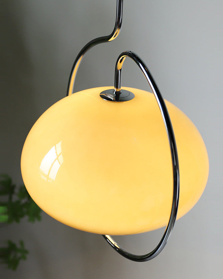 Glossy glass dome of this Clérachic pendant glowing yellow-cream, held on a curved chrome arm with a polished collar.