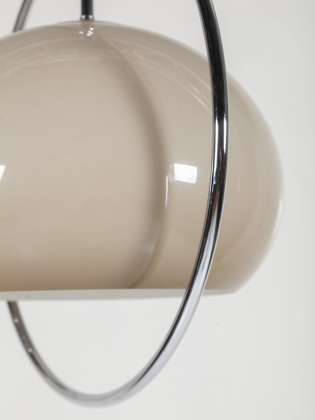 Close view of the glossy taupe-grey glass dome and chrome ring on this Clérachic pendant.