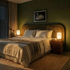 Clérachic ribbed glass dome table lamps in white lit at dusk on twin nightstands beside a green-walled bed.
