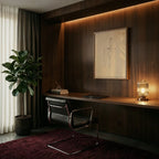 Clérachic ribbed glass dome table lamp in a clear tone, lit on a walnut desk in a moody home office corner.