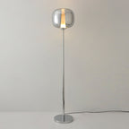 Slim chrome Clérachic floor lamp with a smoked glass head and a light strip, shown lit on a polished base against grey.