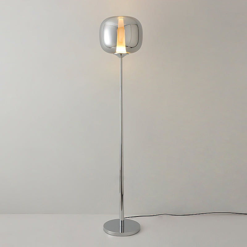 Slim chrome Clérachic floor lamp with a smoked glass head and a light strip, shown lit on a polished base against grey.