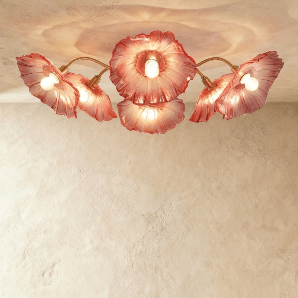 Clérachic six-head ceiling light with red glass flower shades fanned out on slim brass arms, glowing warm.