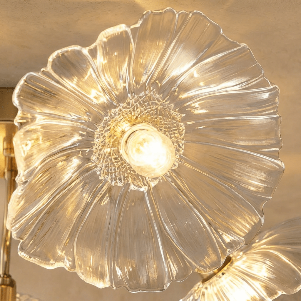 Close view of a Clérachic clear glass flower shade with ribbed petals and a honeycomb-textured centre around a warm bulb.