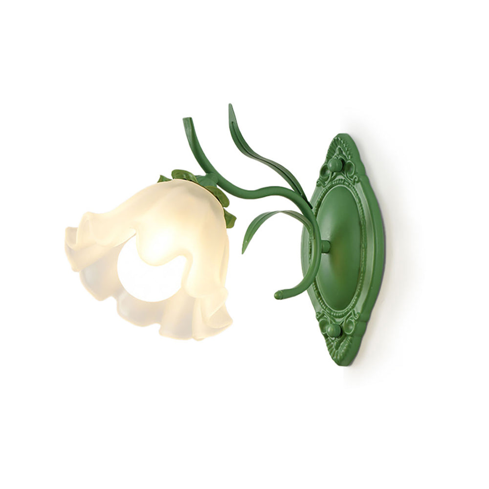 Green Clérachic wall light with a frilled frosted glass flower shade, shown against a white background.