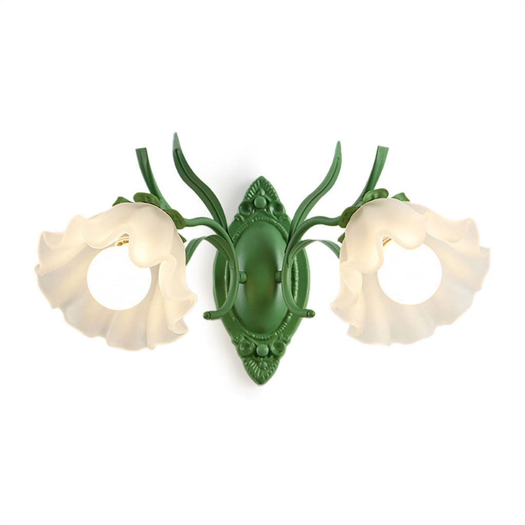 Front view of a green Clérachic double wall light with two ruffled frosted flower shades, on a white backdrop.