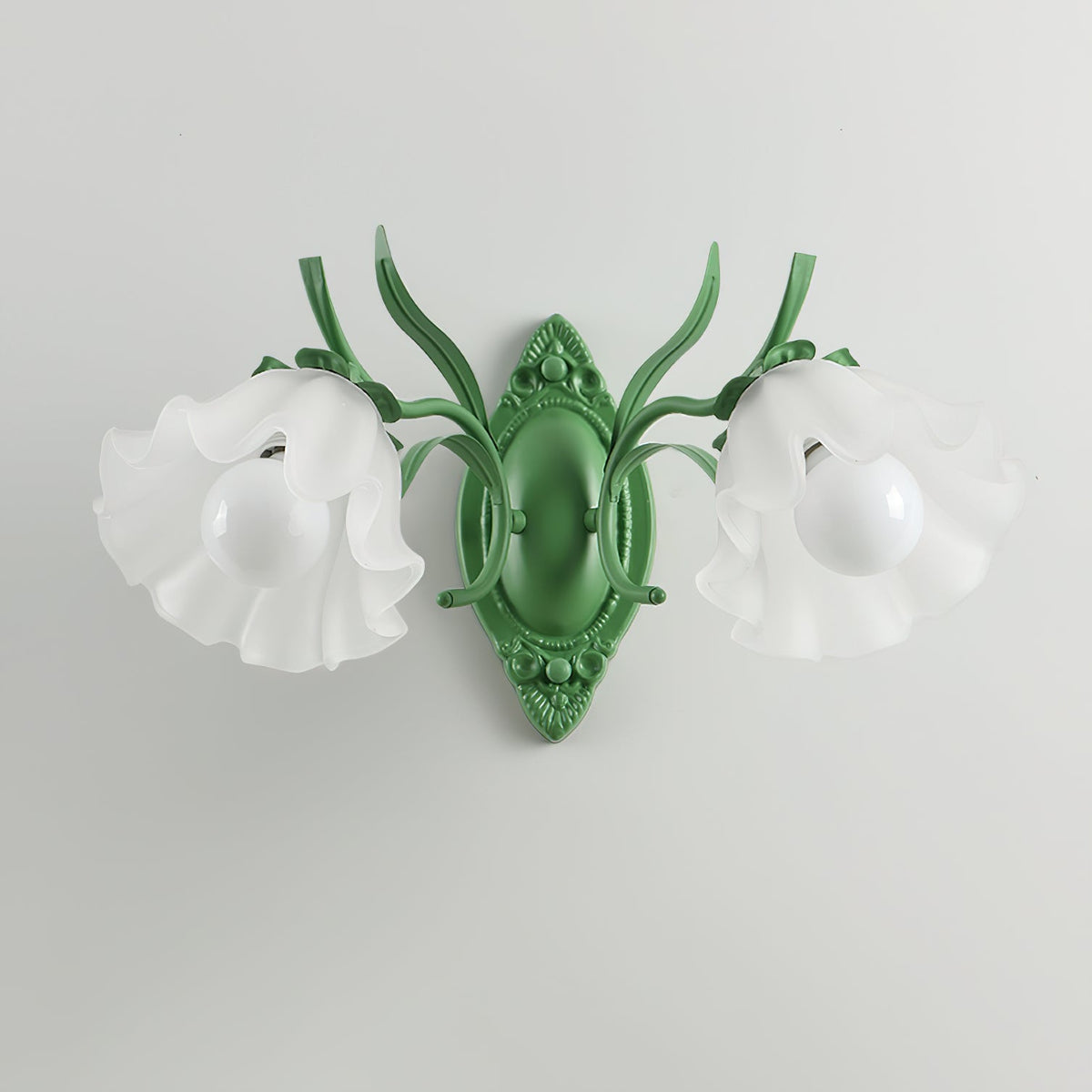 Unlit green Clérachic double wall light with two frosted flower shades and white bulbs, on a light grey wall.