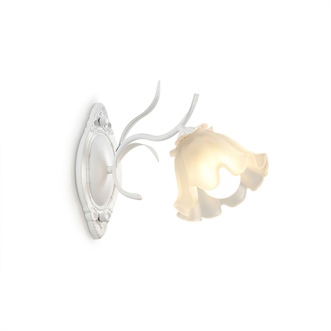 A white Clérachic wall light with a single ruffled flower shade and a branching arm, on a white background.