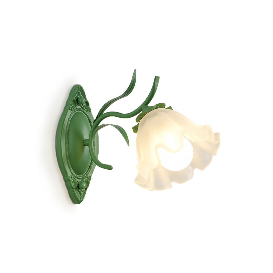 Green Clérachic wall light with one frilled frosted flower shade and leaf details, shown on a white background.