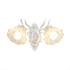 White Clérachic double wall light with two ruffled flower shades, lit, on a white background.