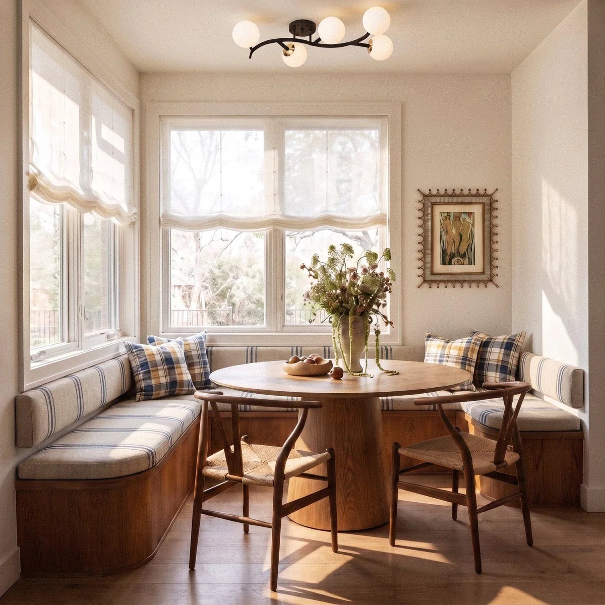 Clérachic black-armed ceiling light with opal white globes above a round table in a bright window nook.