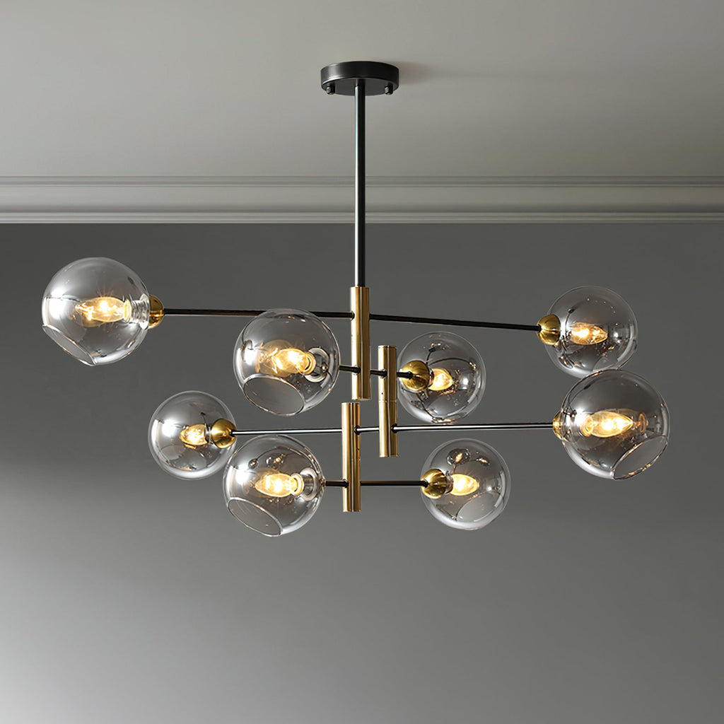 Eight-head Clérachic chandelier with smoky grey globes, lit and hung from a black rod below a pale ceiling.