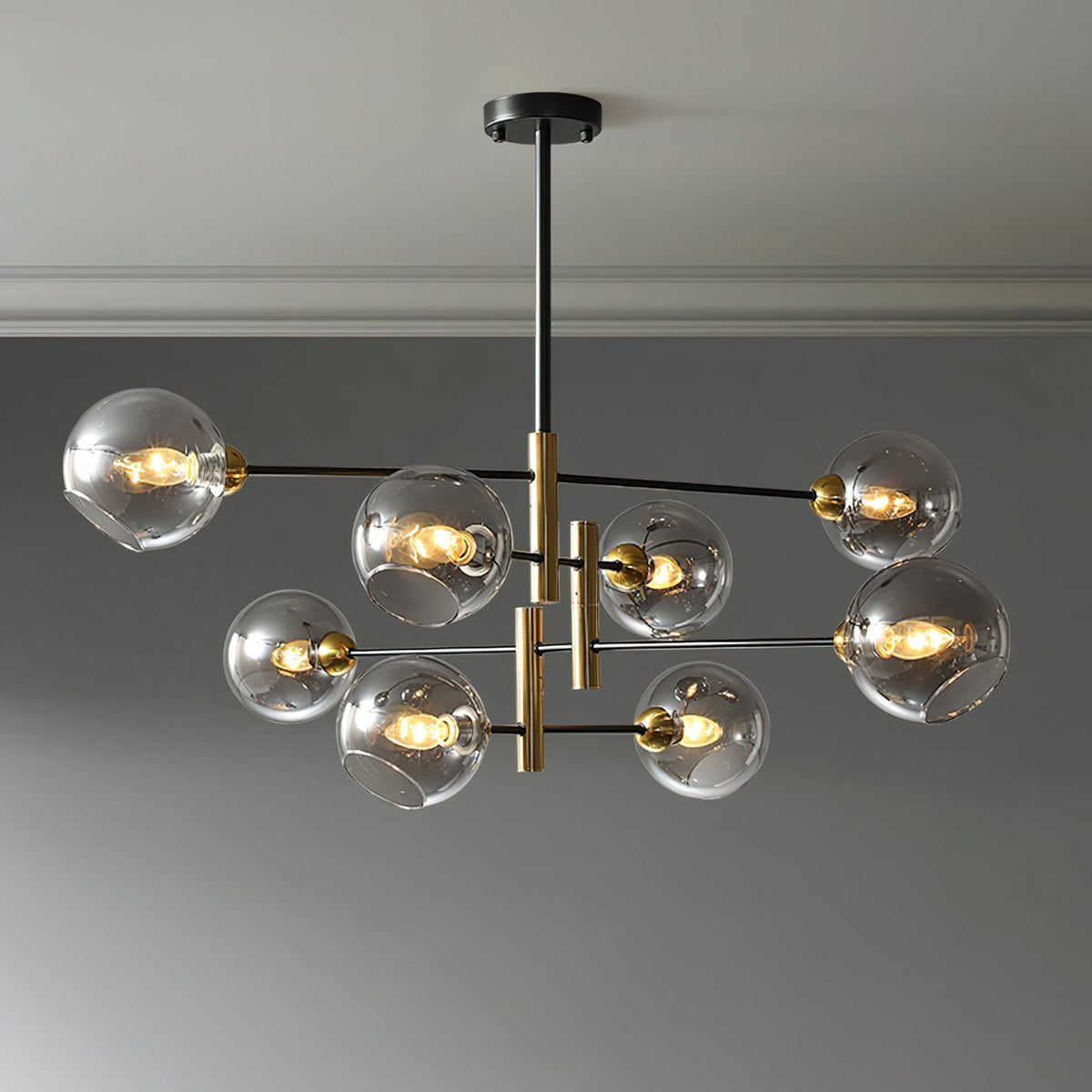 Eight-head Clérachic chandelier with smoky grey globes, lit and hung from a black rod below a pale ceiling.