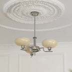 Clérachic three-head chrome chandelier in cream glass, hung beneath a decorative white ceiling rose.