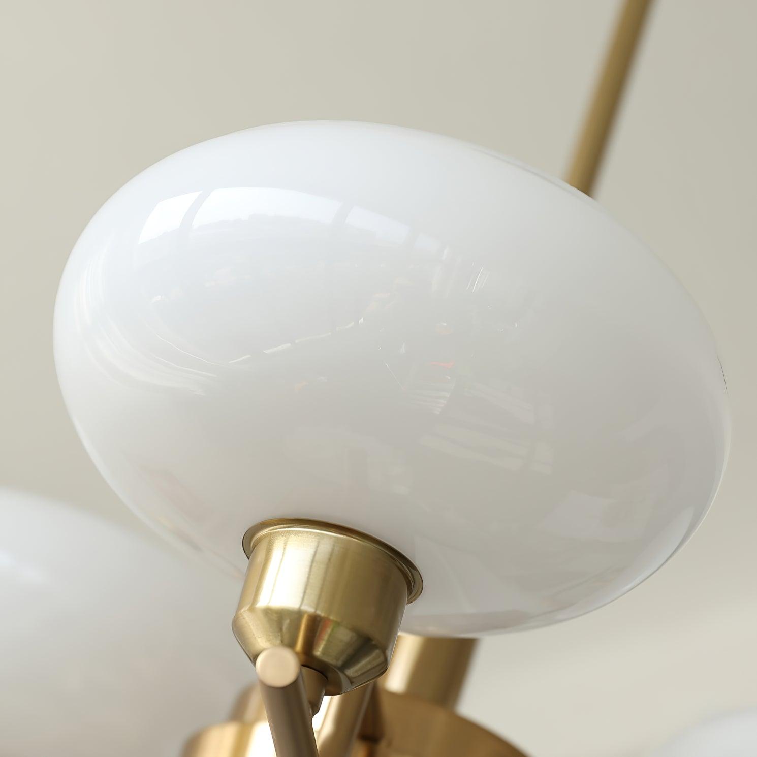 Close-up of a Clérachic white opal globe seated in its brushed copper socket cup and slim arm.