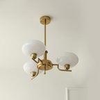 Clérachic three-head copper chandelier, compact with white glass globes, hung in a plain painted corner.