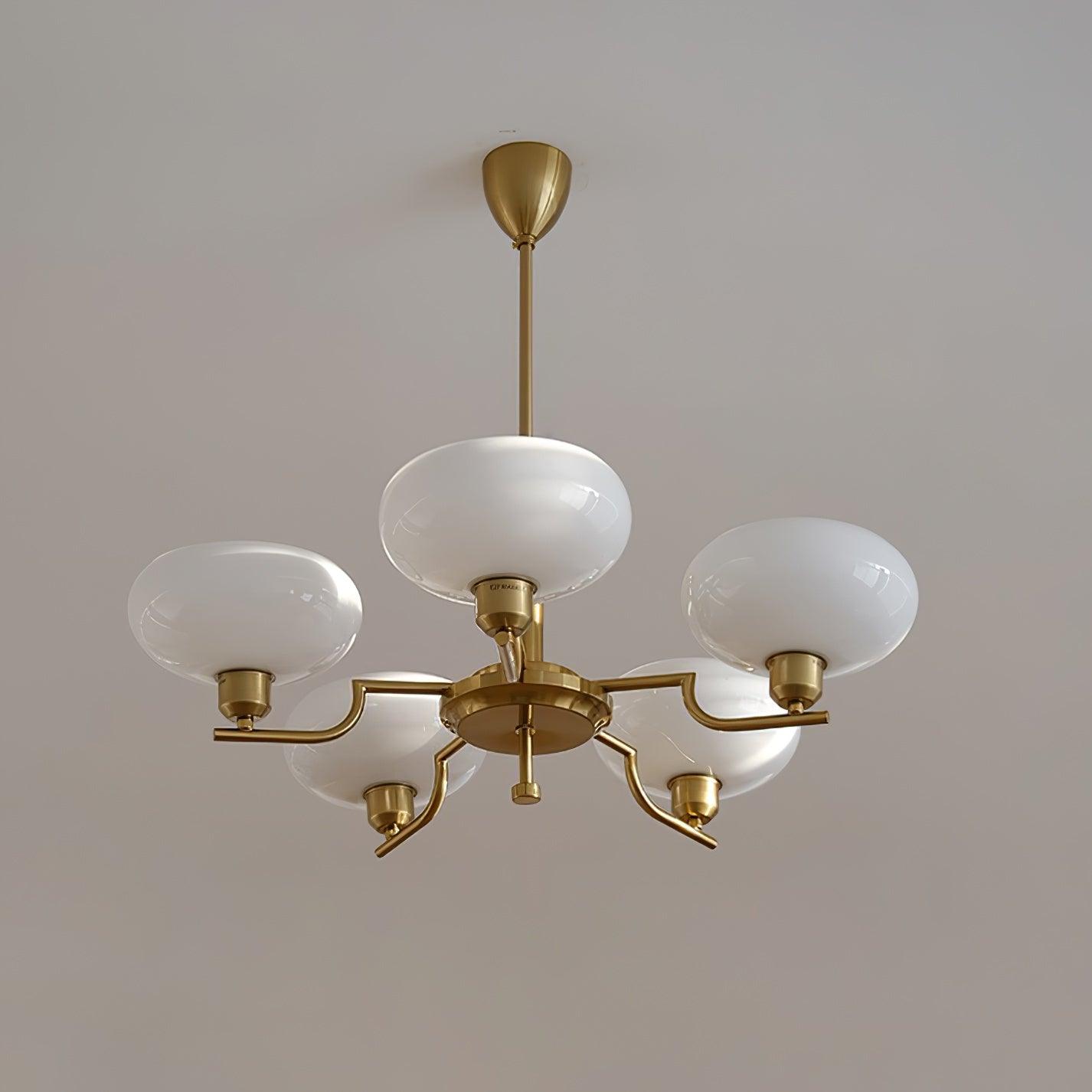 Clérachic five-head copper chandelier with one globe on the hub and four on stepped arms, white ceiling.