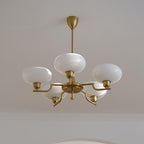Clérachic five-head copper chandelier unlit, one globe under the stem and four on stepped copper arms.
