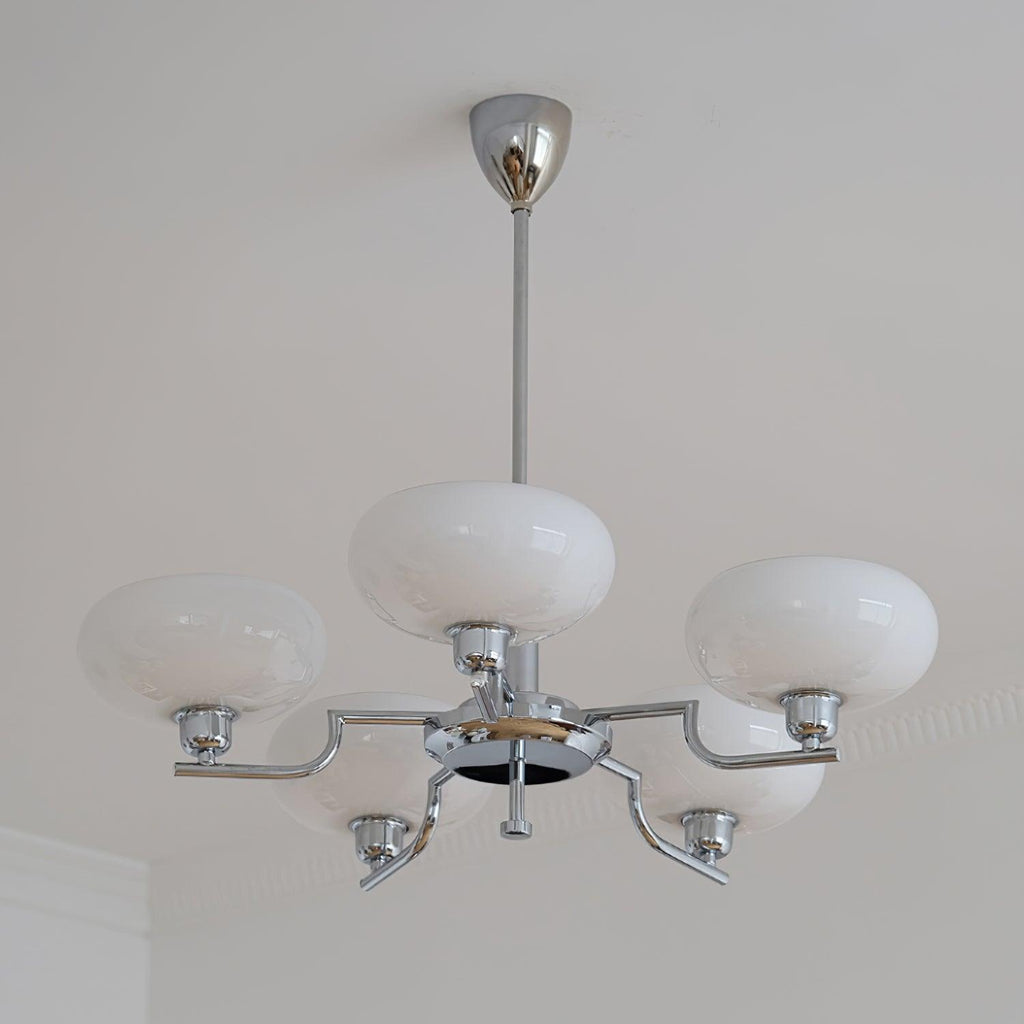 Clérachic five-head chrome chandelier unlit, one globe on the hub and four on bent chrome arms.