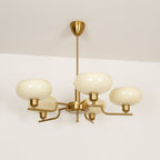 Clérachic five-head copper chandelier in cream glass, studio view of five upright globes on a pale backdrop.