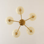 Clérachic five-head copper chandelier from directly below, five unlit white globes in a star pattern.