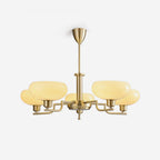 Clérachic five-head copper chandelier unlit in studio, cream elliptical globes on a neutral grey backdrop.