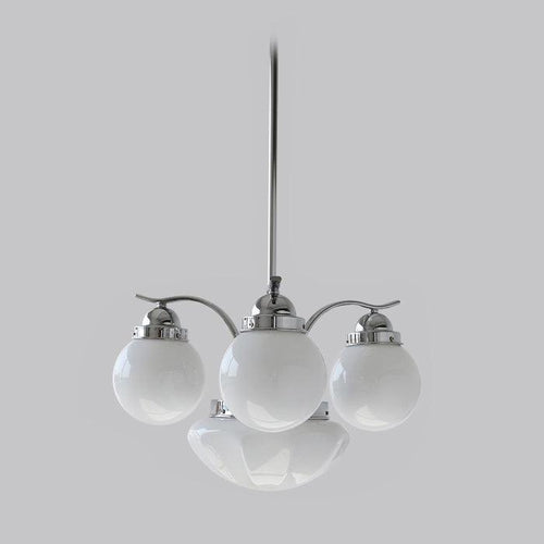Clérachic 4-light glass globe chandelier in chrome, three white globes and a shallow bowl on a long downrod.