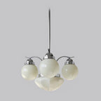 The Clérachic chrome 4-light glass globe chandelier lifts one globe high between two side globes and a fluted bowl.