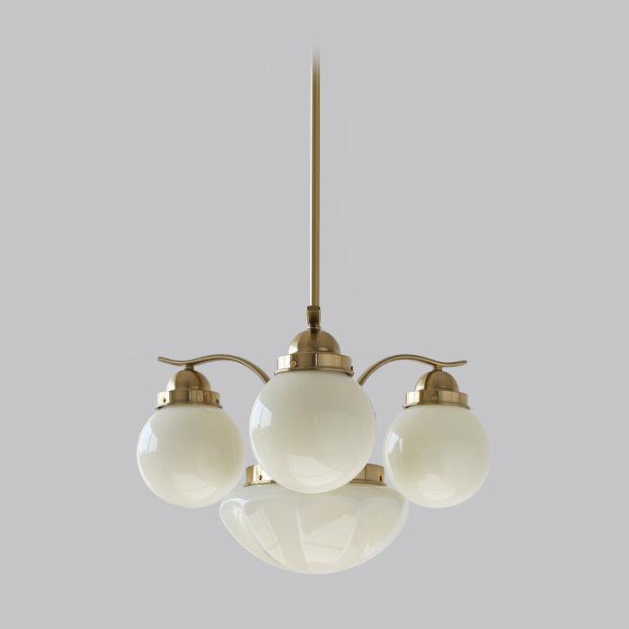 Clérachic 4-light glass globe chandelier in copper-plated metal, white globes ringing a fluted central bowl.