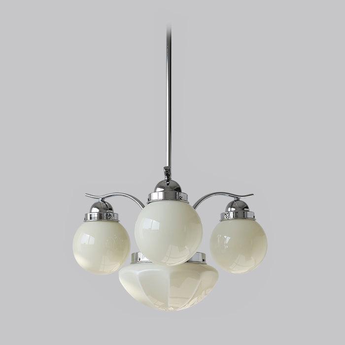 A Clérachic chrome glass globe chandelier in the 4-light layout, cream globes clustered above the bottom bowl.