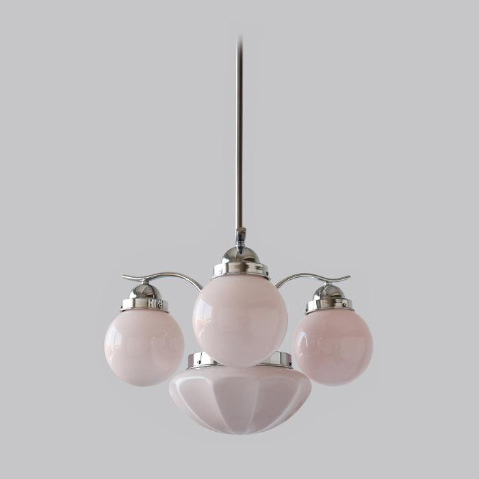 The Clérachic chrome 4-light glass globe chandelier pairs pink milk-glass globes with a matching scalloped bowl.