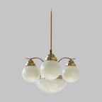 The Clérachic 4-light copper-plated glass globe chandelier sits unlit, milk-glass globes on a satin copper frame.