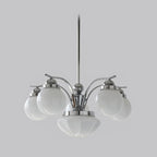 The Clérachic chrome 6-light glass globe chandelier fans white globes from a polished hub above its fluted bowl.