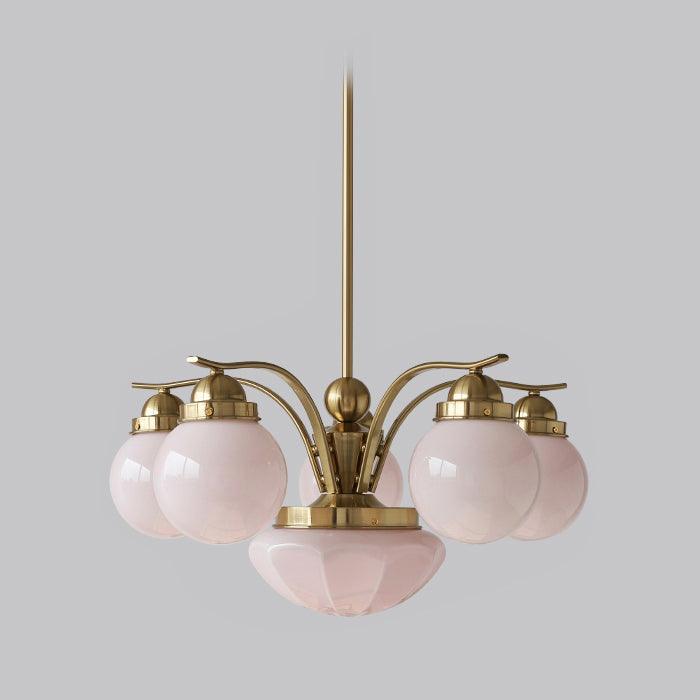 The Clérachic copper-plated 6-light glass globe chandelier gathers blush-pink globes around a pink central bowl.