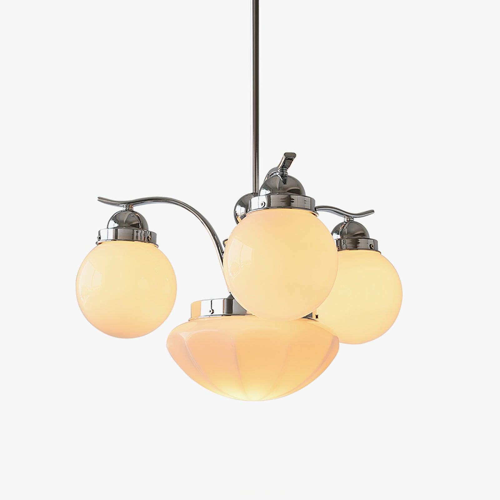 Clérachic chrome 4-light glass globe chandelier glowing amber-warm, cream globes and a fluted bowl on white.