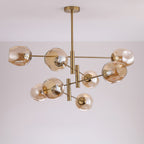 Amber glass globes in an uneven, dimpled shape on this Clérachic gold chandelier, shown from below against a pale ceiling.