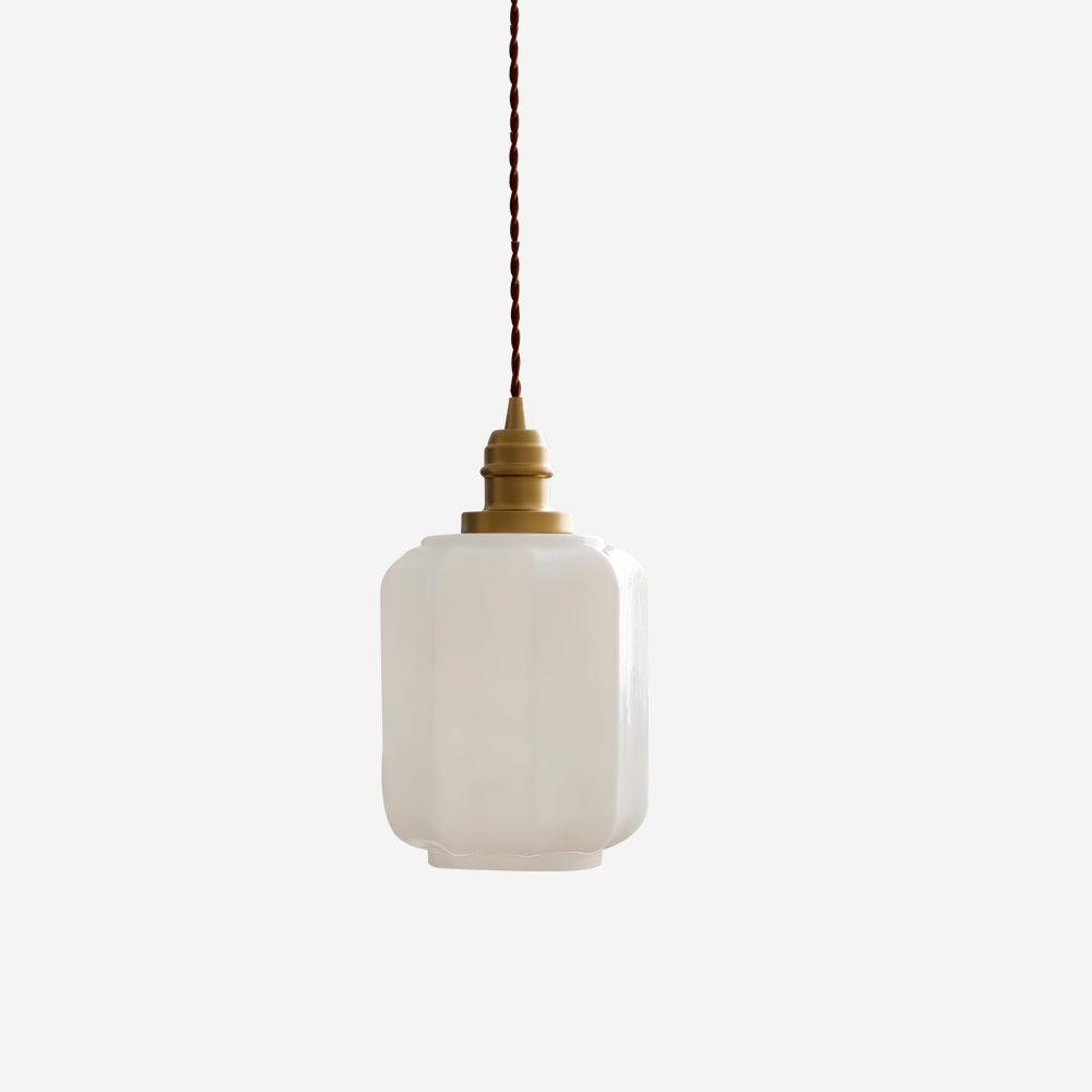 Clérachic glass globe pendant light shown unlit against a plain grey backdrop, faceted opal shade beneath its brass cap.