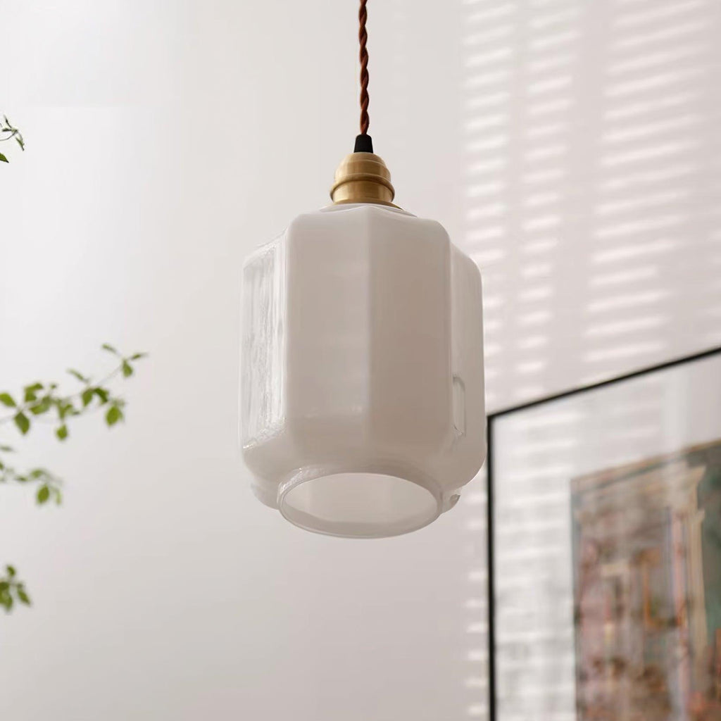 Clérachic glass globe pendant light glowing softly near a sheer curtain and framed artwork in a sunlit room.