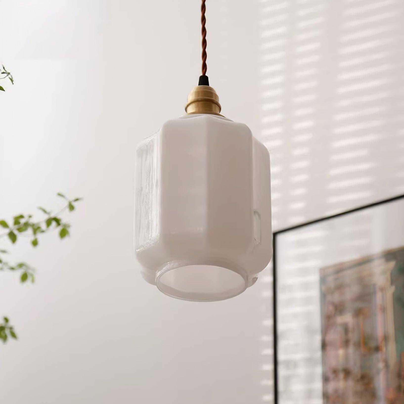Clérachic glass globe pendant light glowing softly near a sheer curtain and framed artwork in a sunlit room.
