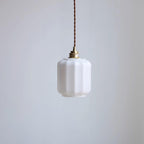 Clérachic glass globe pendant light in a front-facing unlit product shot with its full brass fitting and cord visible.