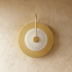 Clérachic single-head brass wall lamp, switched off, with a round backplate and a clear textured glass dome in a diamond pattern.