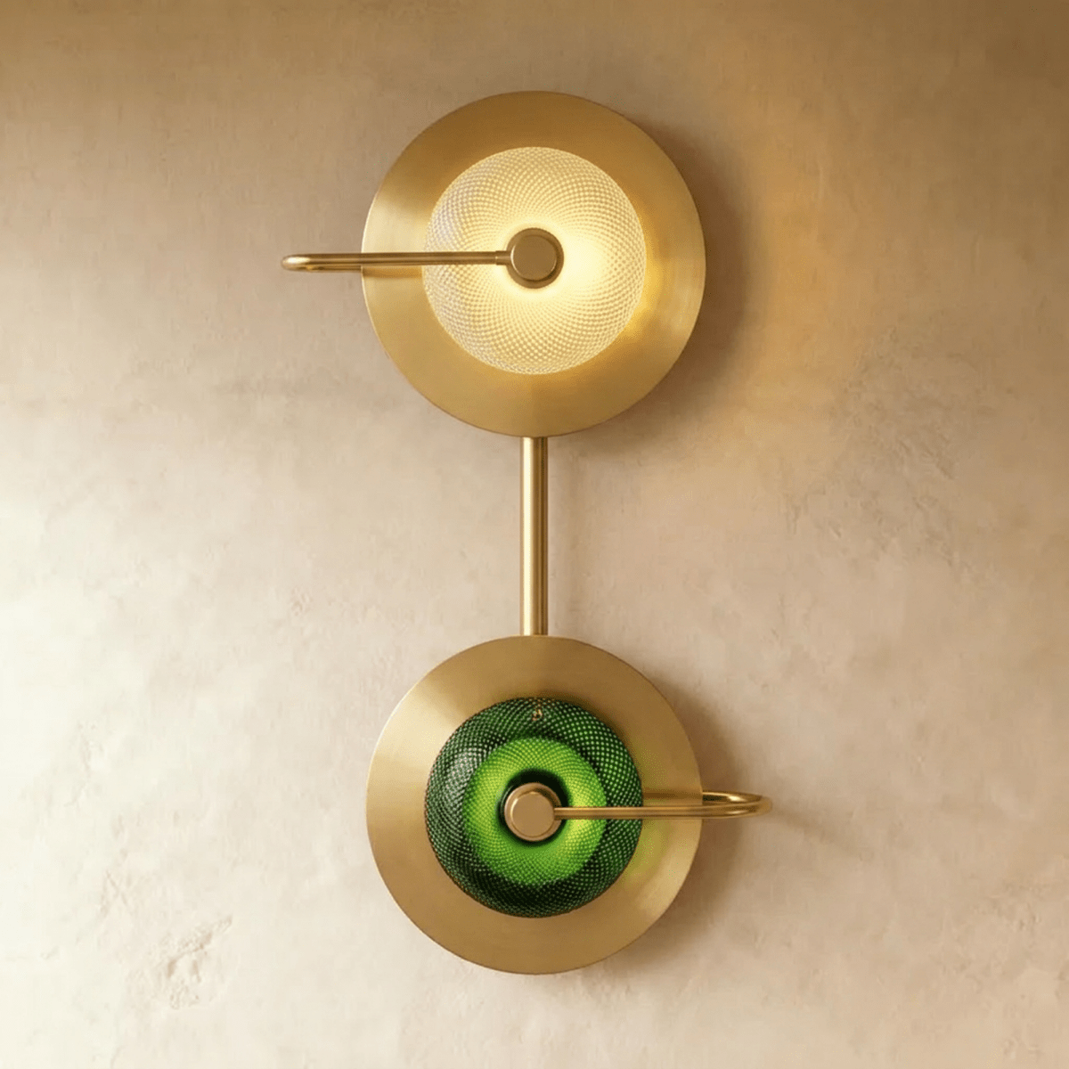 Clérachic two-head brass wall lamp stacking a clear textured glass dome above a green one, joined by a slim brass stem.
