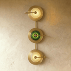 Clérachic three-head brass wall lamp with two clear textured glass domes either side of a green one on a vertical brass stem.