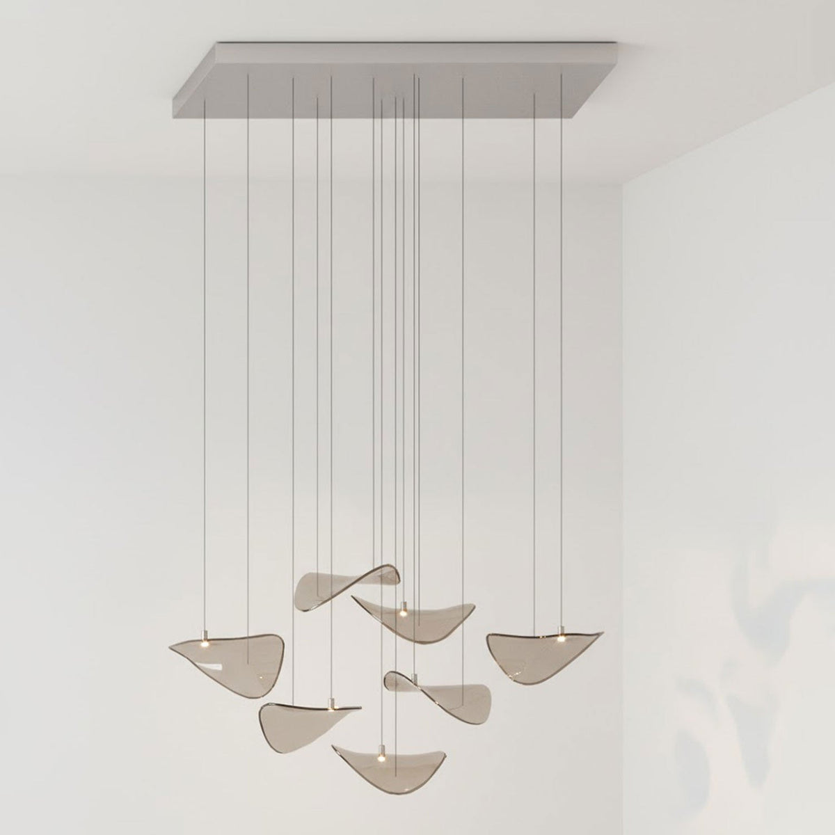 Rectangular grey canopy and a small group of tilted amber glass leaves on long drops, from this Clérachic leaf pendant.
