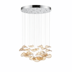 Round chrome canopy with fine cables and a cluster of amber glass leaves hanging beneath, on a white backdrop, from Clérachic.