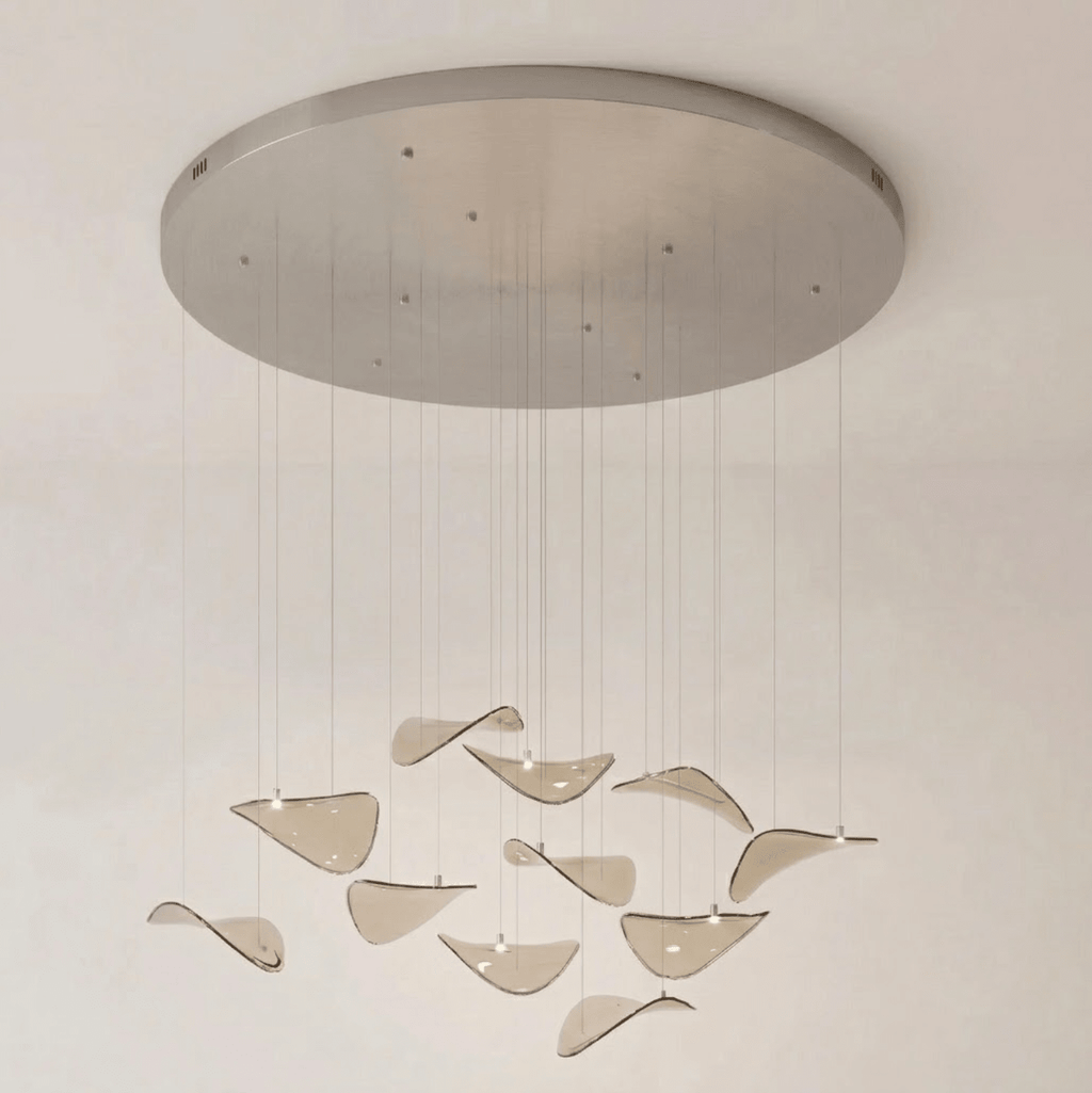 Wide round brushed canopy with a few small fixings and amber glass leaves hung on long drops, from Clérachic.